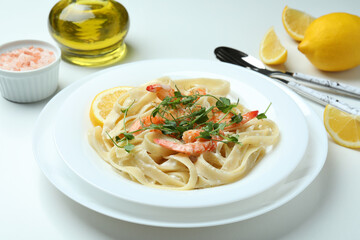Concept of tasty eating with shrimp pasta on white background