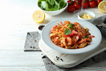 Concept of cooking shrimp pasta on white wooden table