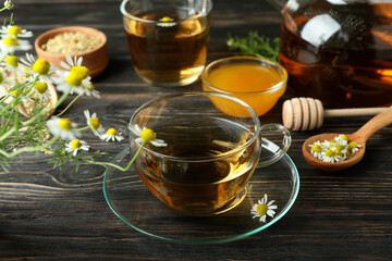 Concept of cooking chamomile tea on rustic wooden table