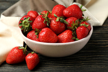 Concept of tasty eating with fresh strawberry on wooden table