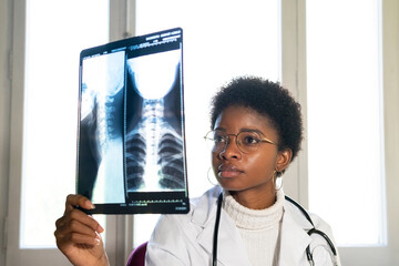 African American doctor examining x ray image