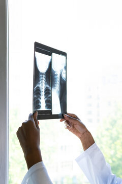 African American doctor examining x ray image