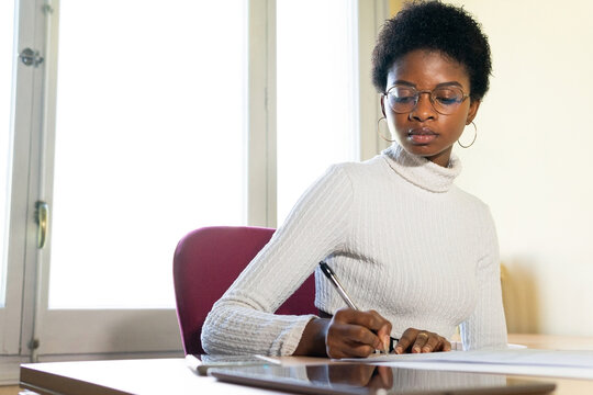 Ethnic doctor working with documents in clinic