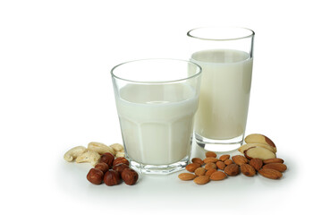 Glasses of milk and nuts isolated on white background