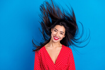 Portrait of attractive cheerful lady wind blowing hair beauty glamour isolated over bright blue color background