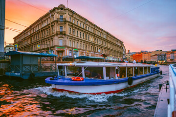 Gorgeous view of the canal in the city center with tourist excursion boats at a bright beautiful...