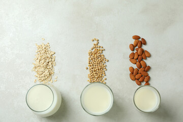 Obraz na płótnie Canvas Concept of vegan milk on white textured background