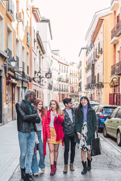 Group of diverse friends walking in city