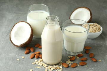 Concept of vegan milk on gray textured background