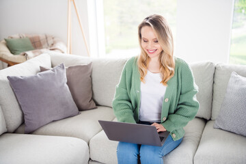 Photo of young attractive woman happy positive smile sit sofa comfort read browse work laptop indoors