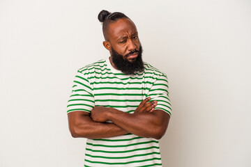 African american man with beard isolated on pink background suspicious, uncertain, examining you.