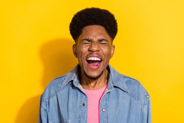 Photo of cheerful young afro american joyful man laugh good mood joke isolated on shine yellow...