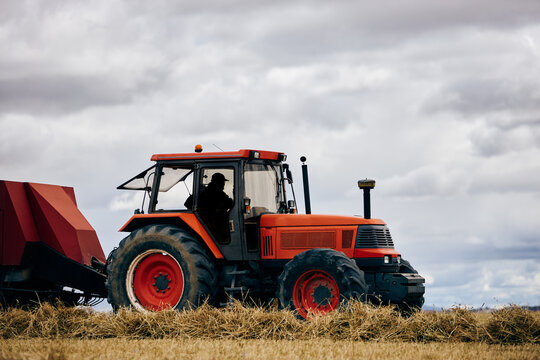 Tractor and haystack on field