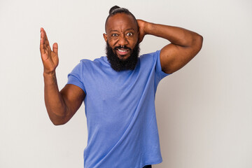 African american man with beard isolated on pink background screaming with rage.