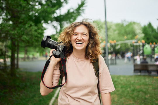Woman with photo camera in summer park