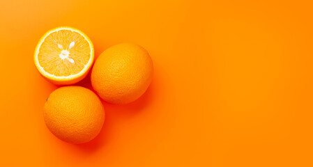 Fresh ripe orange fruit on orange background