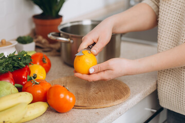 Woman cutting fruits and vegetables