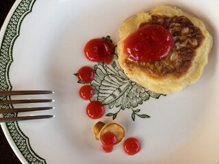 Top view on plate with pancake flavored fresh raspberry fresh and honey mix drops