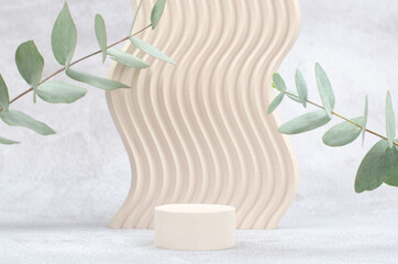 Podium with geometric shapes for product presentation. Empty showcase for advertising cosmetic products with eucalyptus. Mockup