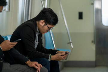 Business people and office worker with smartphone in subway while traveling to work passengers traveling concept.