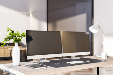 Modern office interior with desktop, empty black computer monitors and other items. Mock up, 3D Rendering.