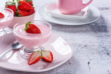 Delicious strawberry mousse in glass bowl with fresh strawberries. Copy space
