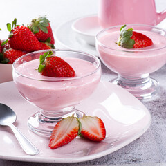 Delicious strawberry mousse in glass bowl with fresh strawberries.