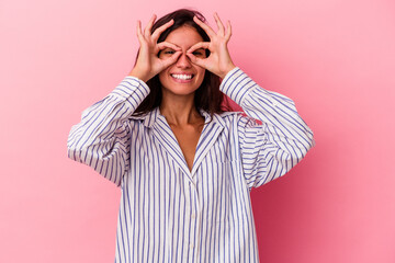 Young caucasian woman isolated on pink background excited keeping ok gesture on eye.