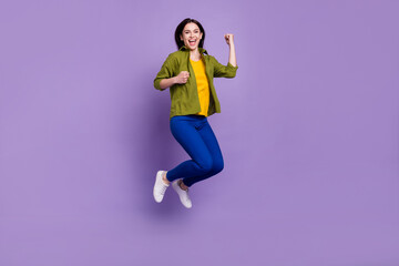 Fototapeta na wymiar Full size profile side photo of young girl happy positive smile winner success ecstatic fists hands jump isolated over violet color background