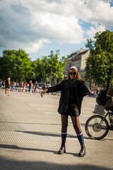 Beautiful country girl in 90s style. Back in time 90s 80s. Stylish girl in retro colourful vintage coat. dressed in street style clothes with chains around neck for a walk. Youth and lifestyle concept