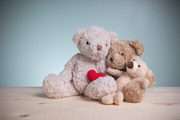 Family hug happy. Brown teddy bears sitting huggy show love, happiness on an old wooden table with copy space. Concept family, love, and valentines festival.
