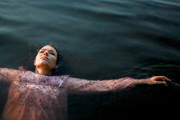 Girl in the water who is thinking about sence of life and her future. Freedom. Calming