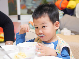 Little chinese boy eating