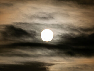 Rising Sun behind The Streaming Gray Clouds