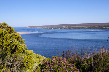 Fototapeta na wymiar The Breede River entering the ocean near Witsand holiday resort in South Africa.