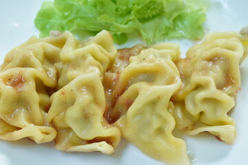 steamed dim sum or Chinese dumpling stuffed mash shrimp and barbecue pork dipping soy sauce on plate