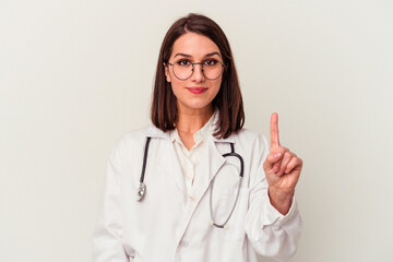 Young doctor caucasian woman isolated on white background showing number one with finger.