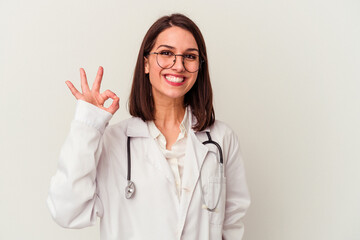 Young doctor caucasian woman isolated on white background cheerful and confident showing ok gesture.