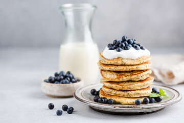 Pancakes with poppy seeds, yogurt and blueberries. Stack of delicious sweet pancakes for breakfast...