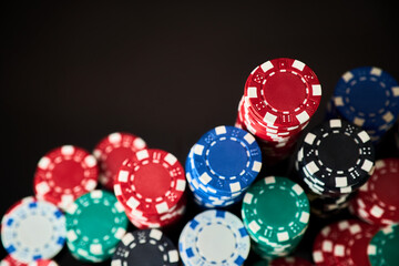 Stack of Casino gambling chips isolated on black reflective background