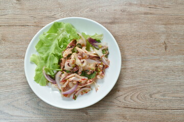 Thai spicy squid salad and fresh vegetable on plate