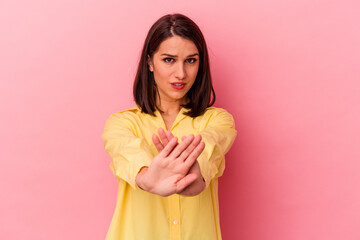 Young caucasian woman isolated on pink background doing a denial gesture