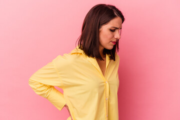 Young caucasian woman isolated on pink background suffering a back pain.