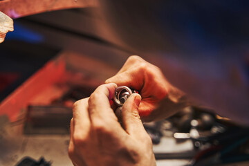 Jewelry master using mandrel for polishing ring - obrazy, fototapety, plakaty