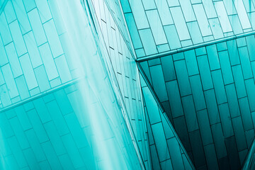 Obraz premium underside panoramic and perspective view to steel blue glass high rise building skyscrapers, business concept of successful industrial architecture