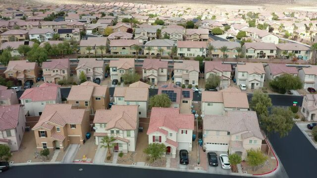 Flying over red tile rooftops of a southwestern suburban neighborhood