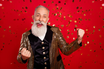 Photo of senior man happy positive smile rejoice victory fly air confetti fists hands isolated over...