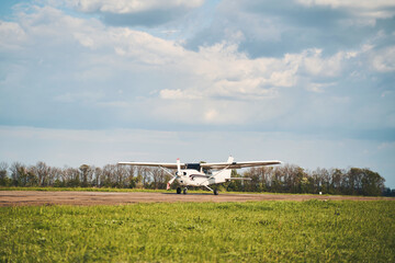 Airfield with light aircraft under beautiful sky