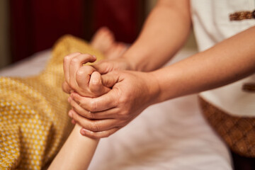 Chiropractor inserting bones on hand of child