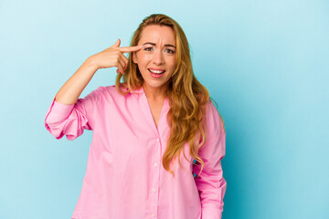 Caucasian woman isolated on blue background showing a disappointment gesture with forefinger.